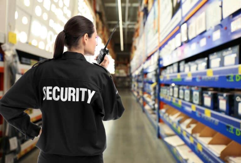 Retail security guard wearing a tactical vest standing in a grocery store in Canada